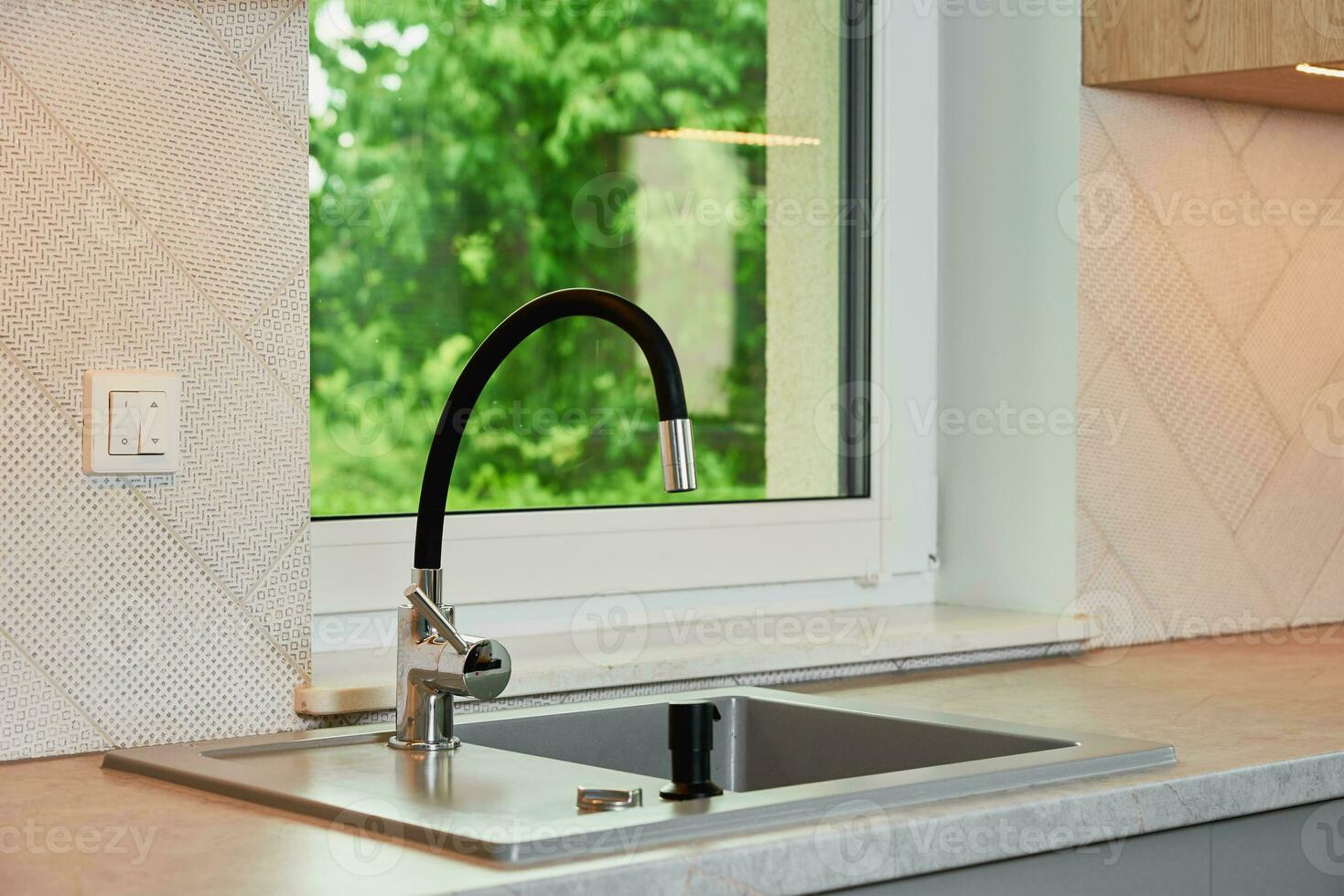 Interior of a modern kitchen with sink near window photo