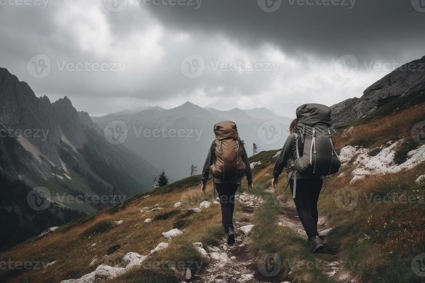 Travelers with backpacks hiking in mountains. photo