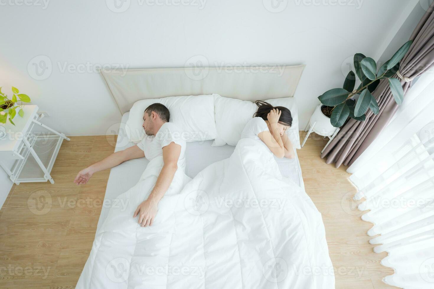 Man snoring in bed and make woman. photo