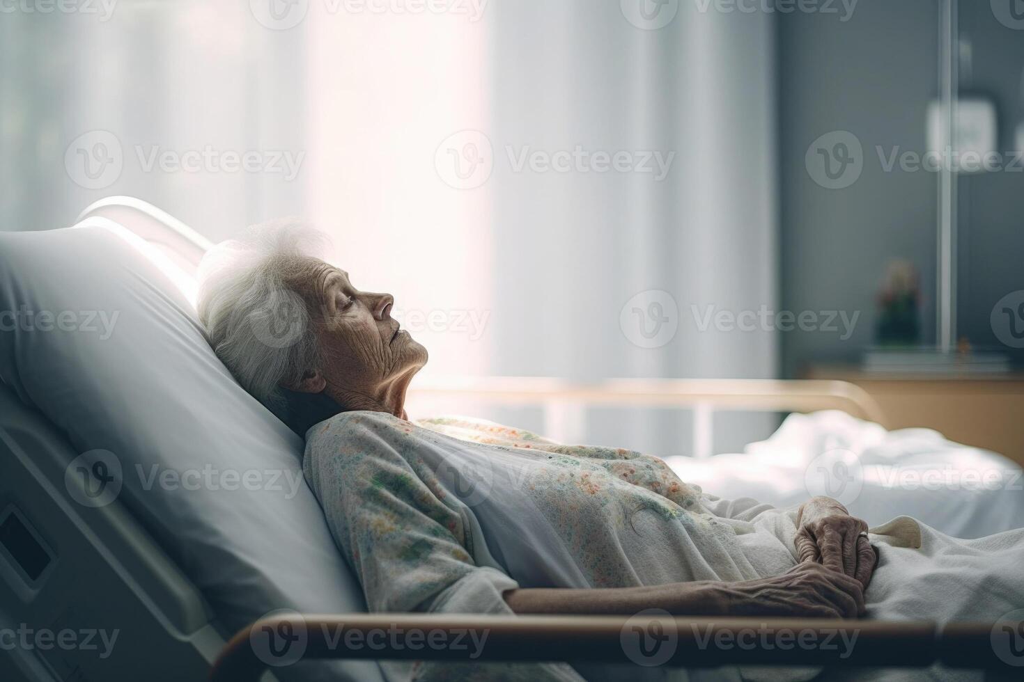 Elderly patient sleeping on bed in hospital ward. photo