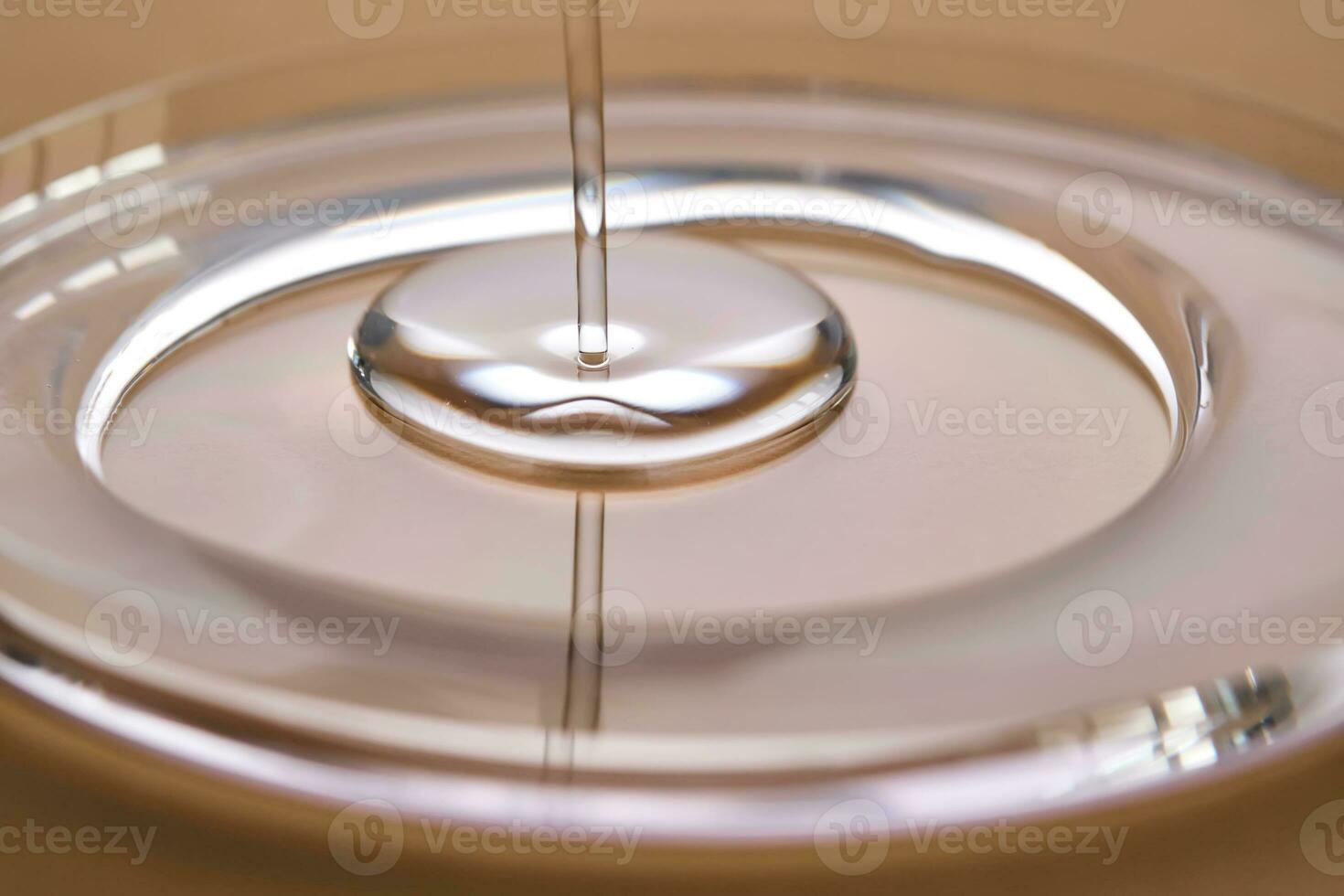 A juicy drop of gel on a beige background. photo