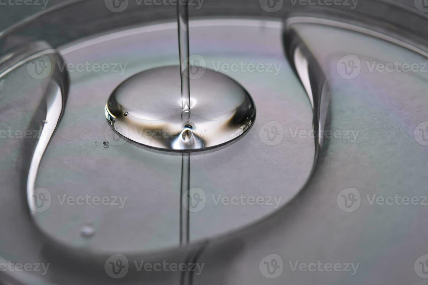 A juicy drop of gel on a grey background. photo