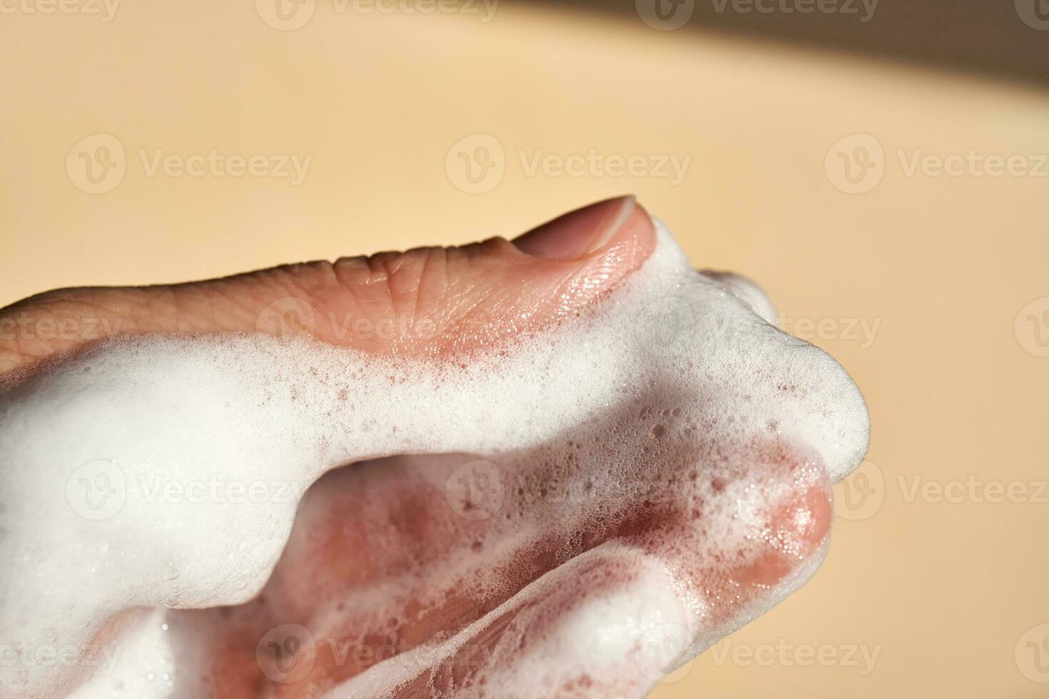 Photo of the texture of cosmetic foam on the hand.