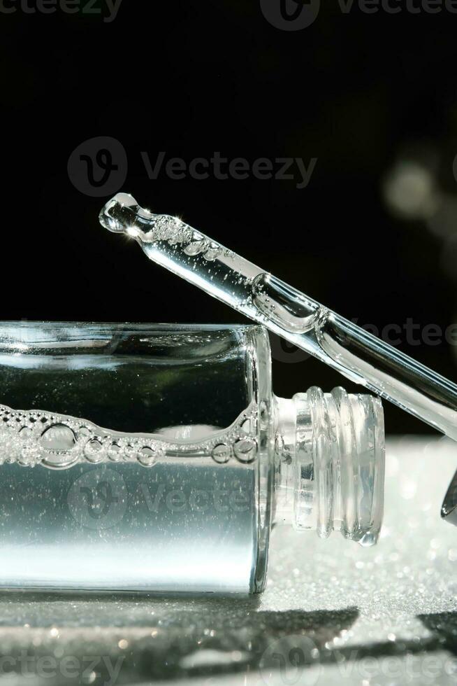 A bottle of serum with a dropper lies on a white background. photo