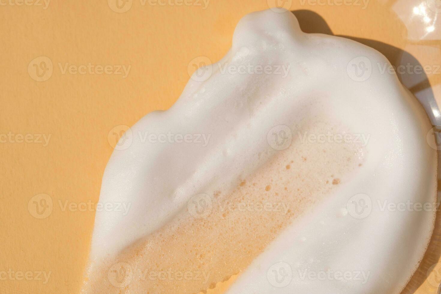 Soap foam on a light beige background. photo