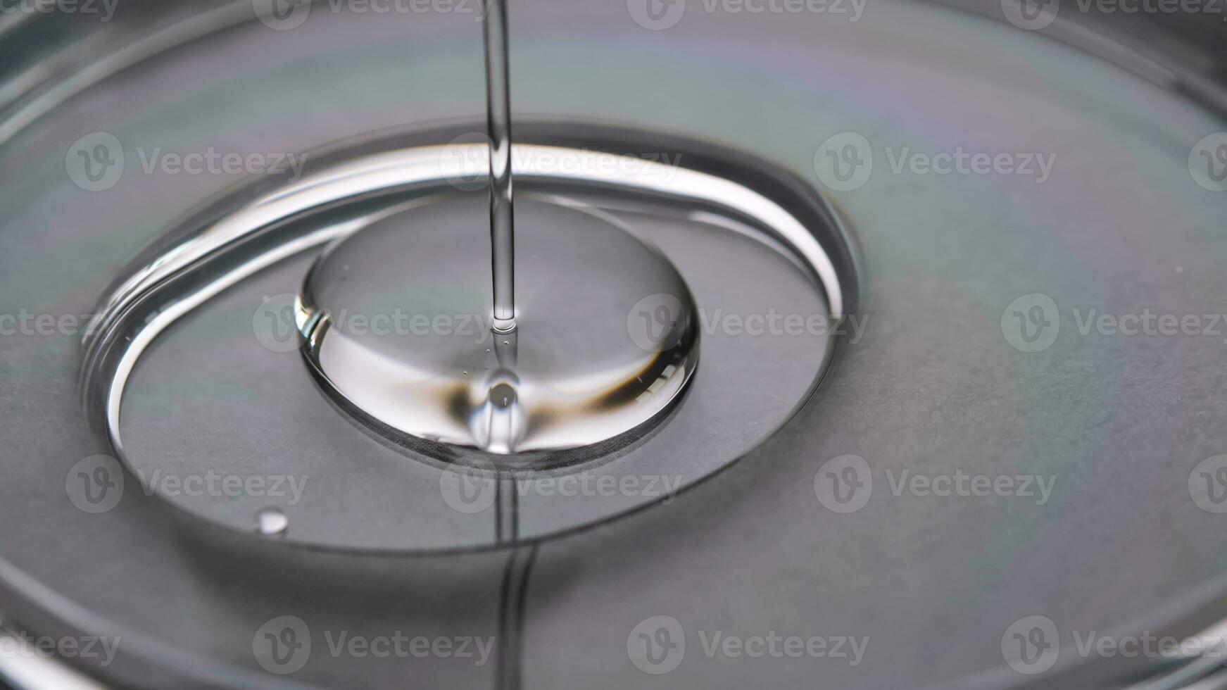 A juicy drop of gel on a grey background. photo