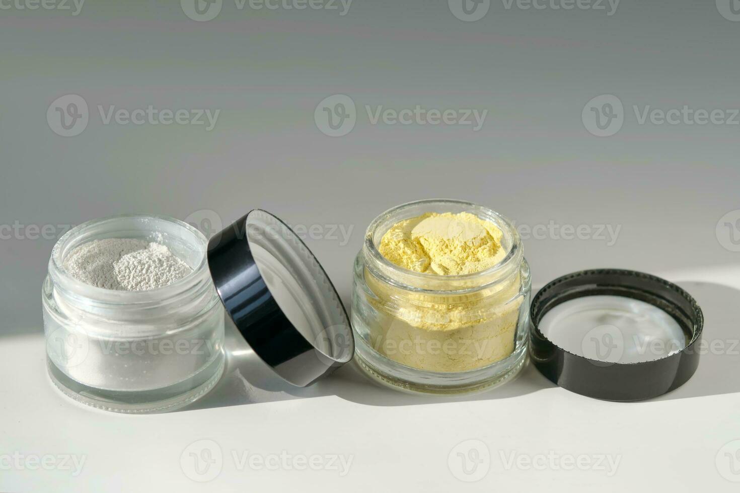 A jar of rice flour face scrub and a jar of turmeric face scrub. photo