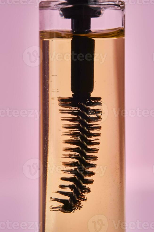 Cosmetic oil for the growth of eyebrows and eyelashes with a brush. photo