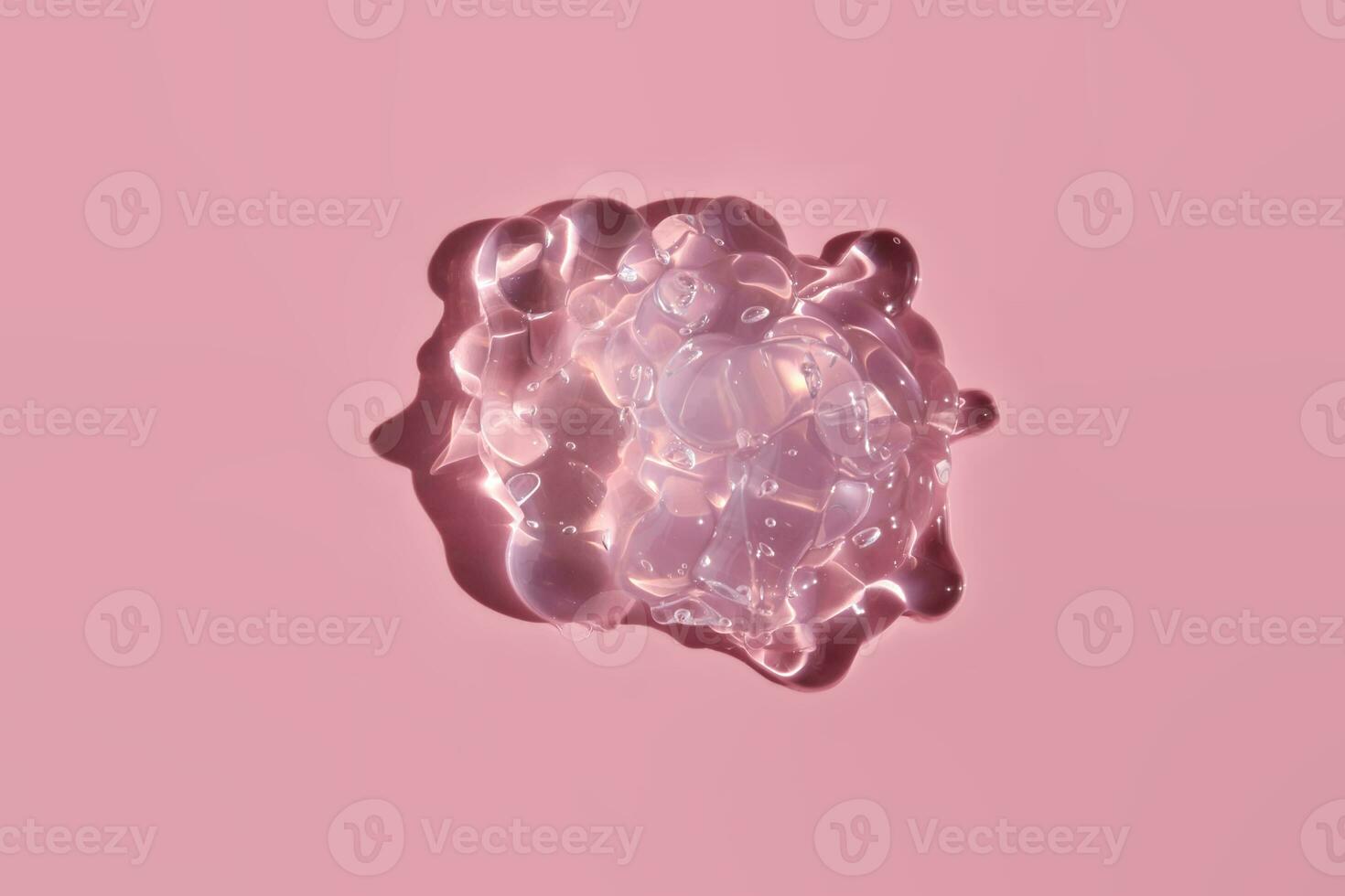 Texture of cosmetic gel on a pink background. photo