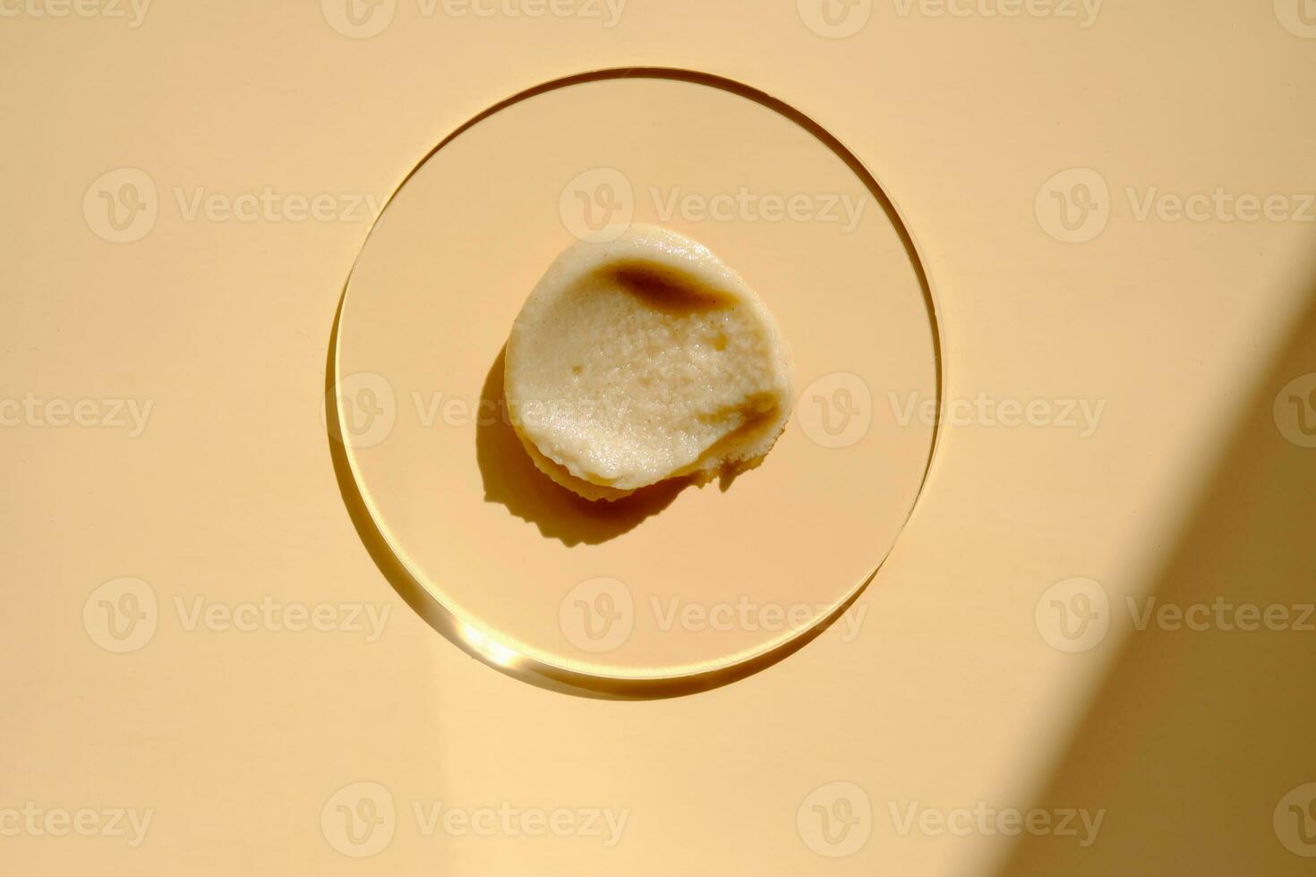 Facial peeling drop swatch on a beige background. photo