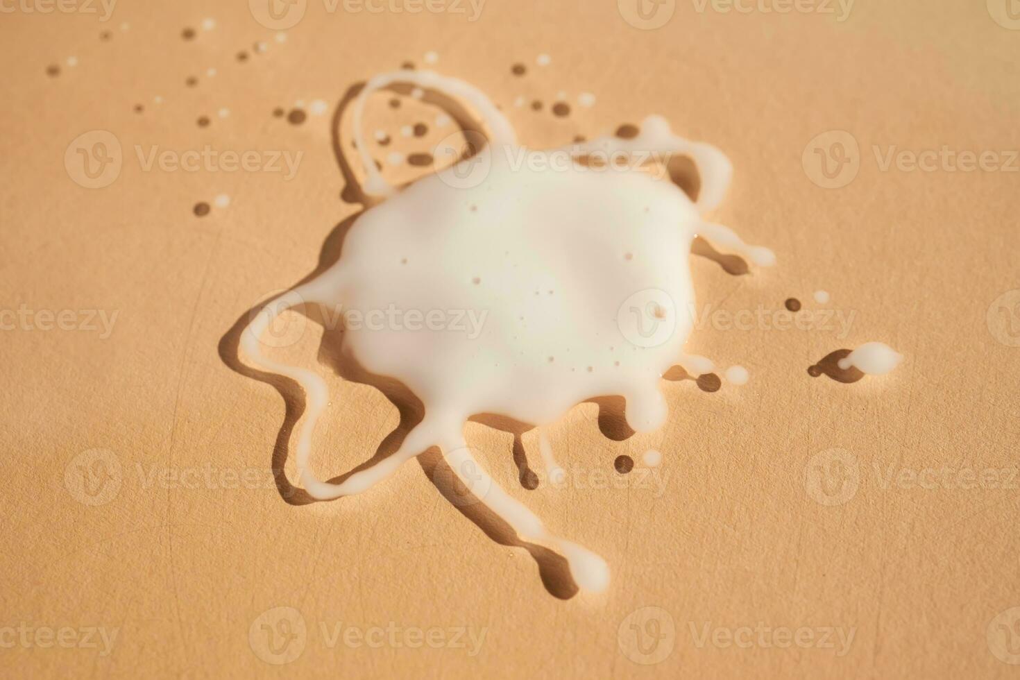 A splattered drop on a beige background. photo