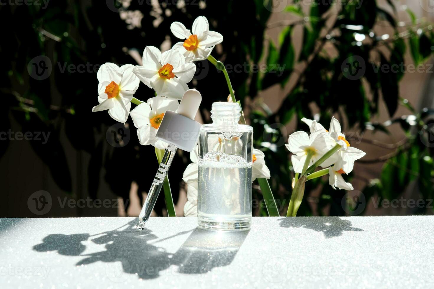 A bottle of serum with a dropper. photo