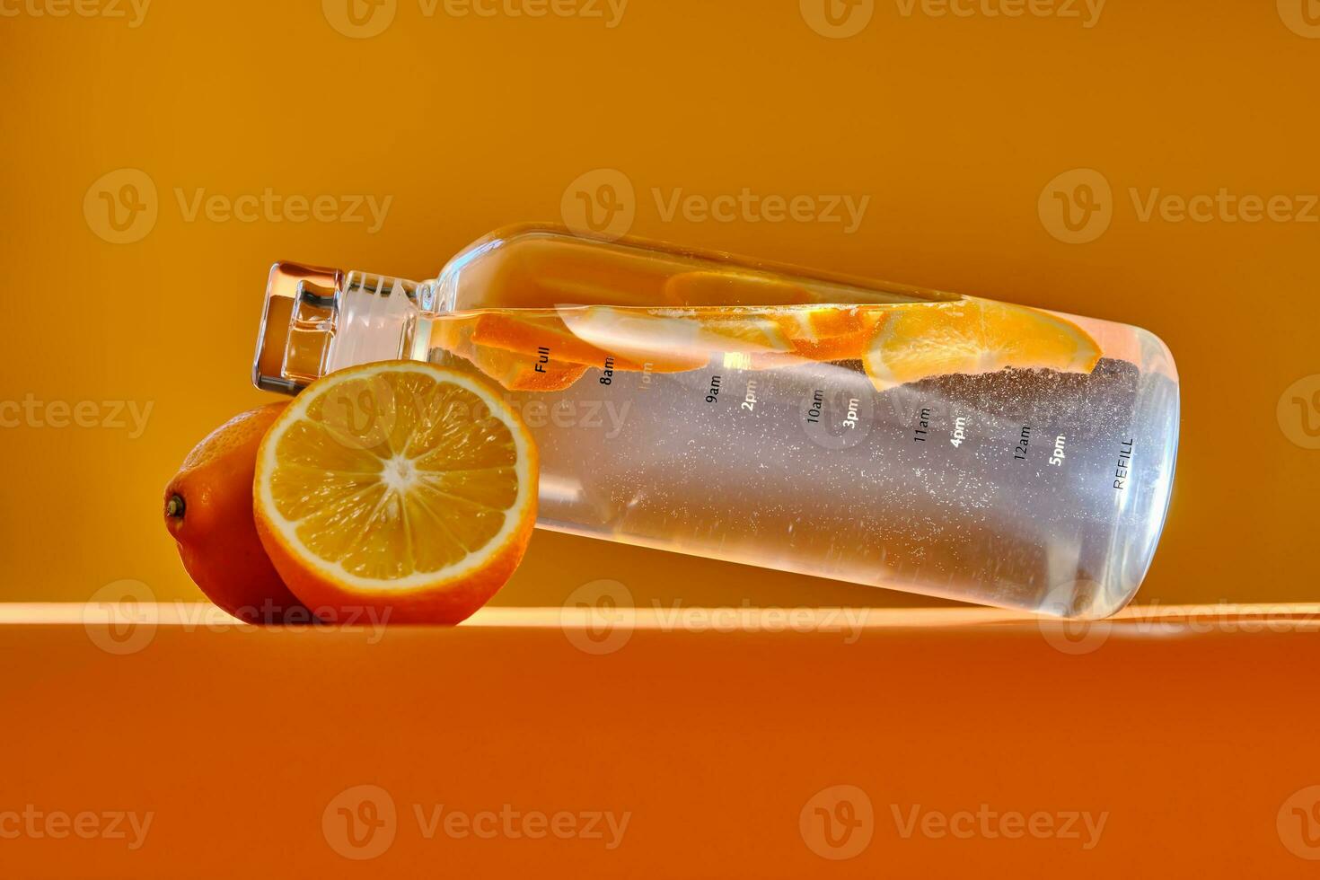 Glass water bottle with lemon. photo