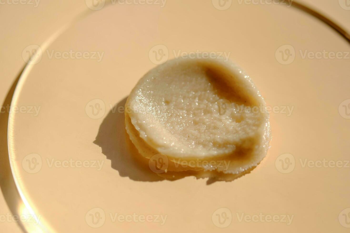 Facial peeling drop swatch on a beige background. photo