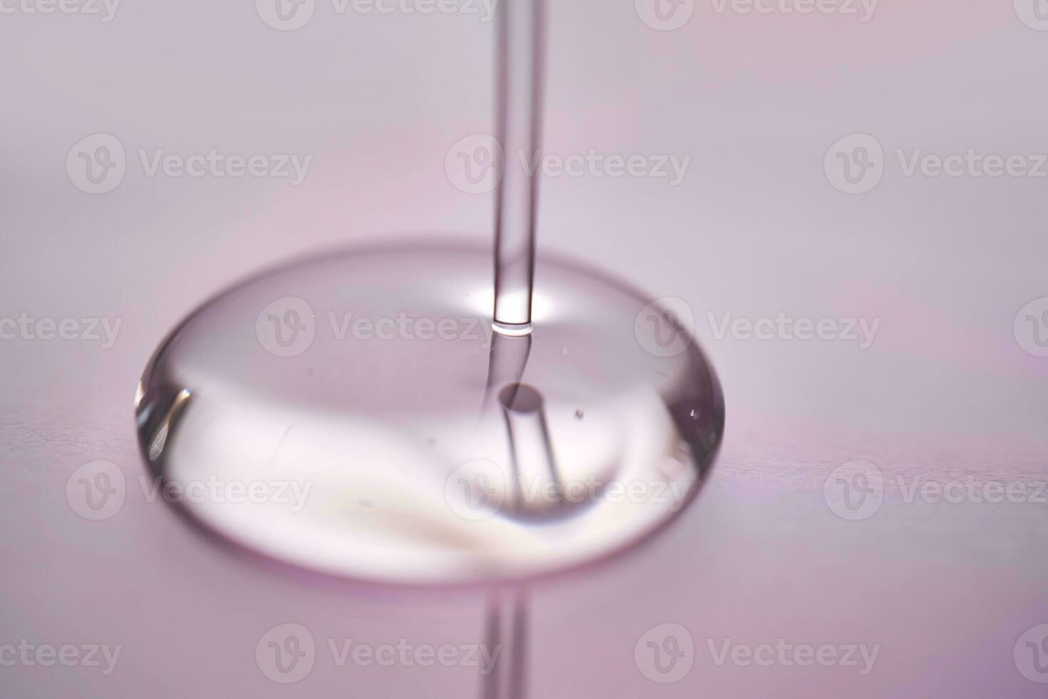 A juicy drop of gel on a purple background. photo