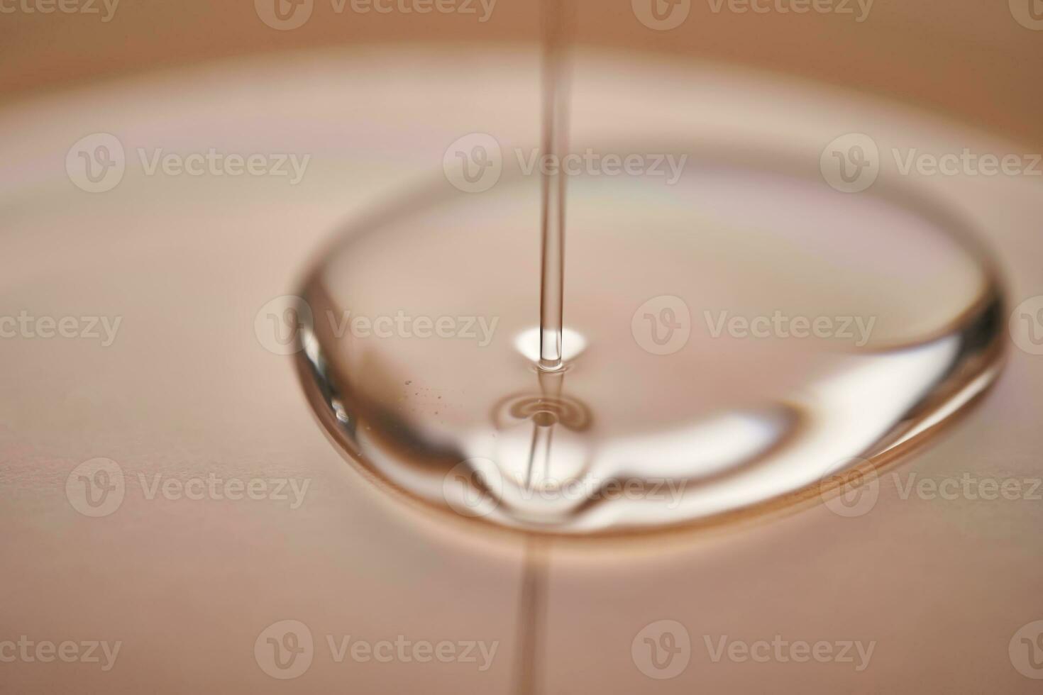 A juicy drop of gel on a beige background. photo