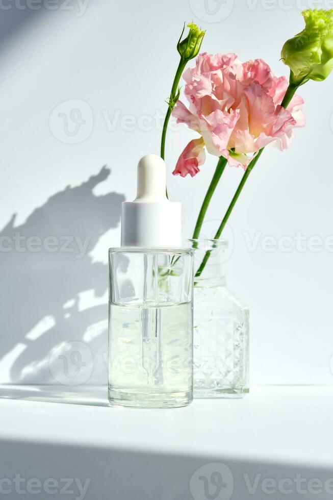 Serum with a dropper with spring flowers. photo