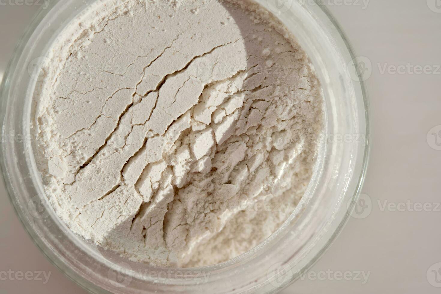 An open jar of face scrub-powder showing off its texture. photo