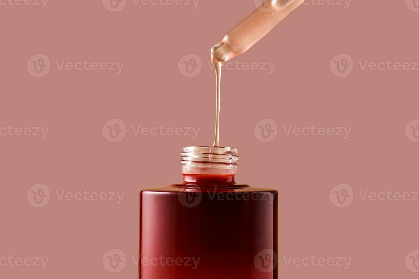 A drop of pink cosmetic drips from the dropper. 24601428 Stock Photo at Vecteezy