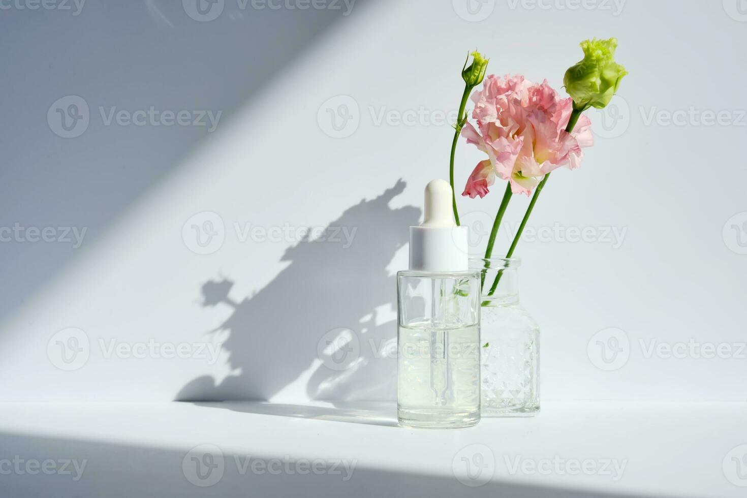 Serum with a dropper with spring flowers. photo