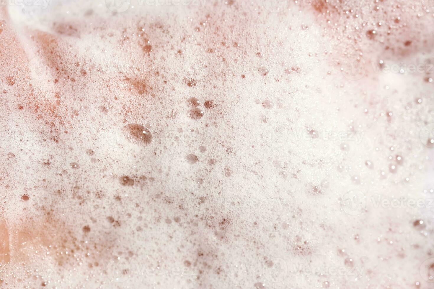 Photo of the texture of cosmetic foam or soap on the hand.