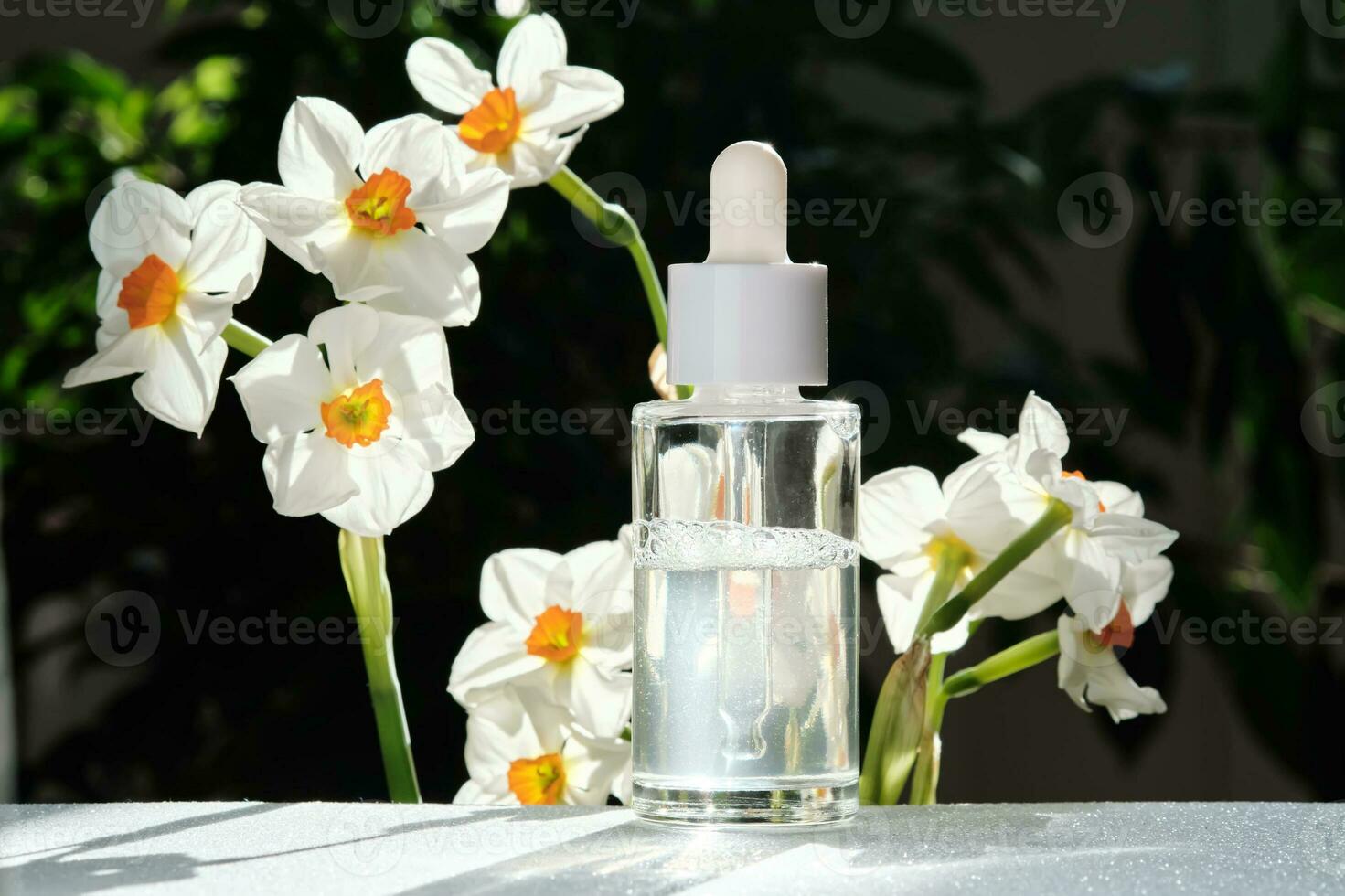 A bottle of serum with a dropper. photo