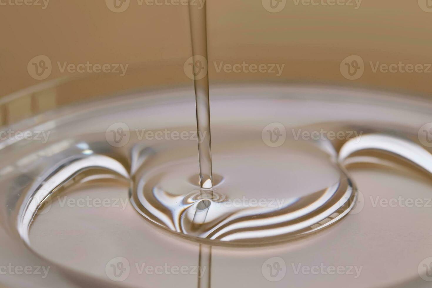 A juicy drop of gel on a beige background. photo