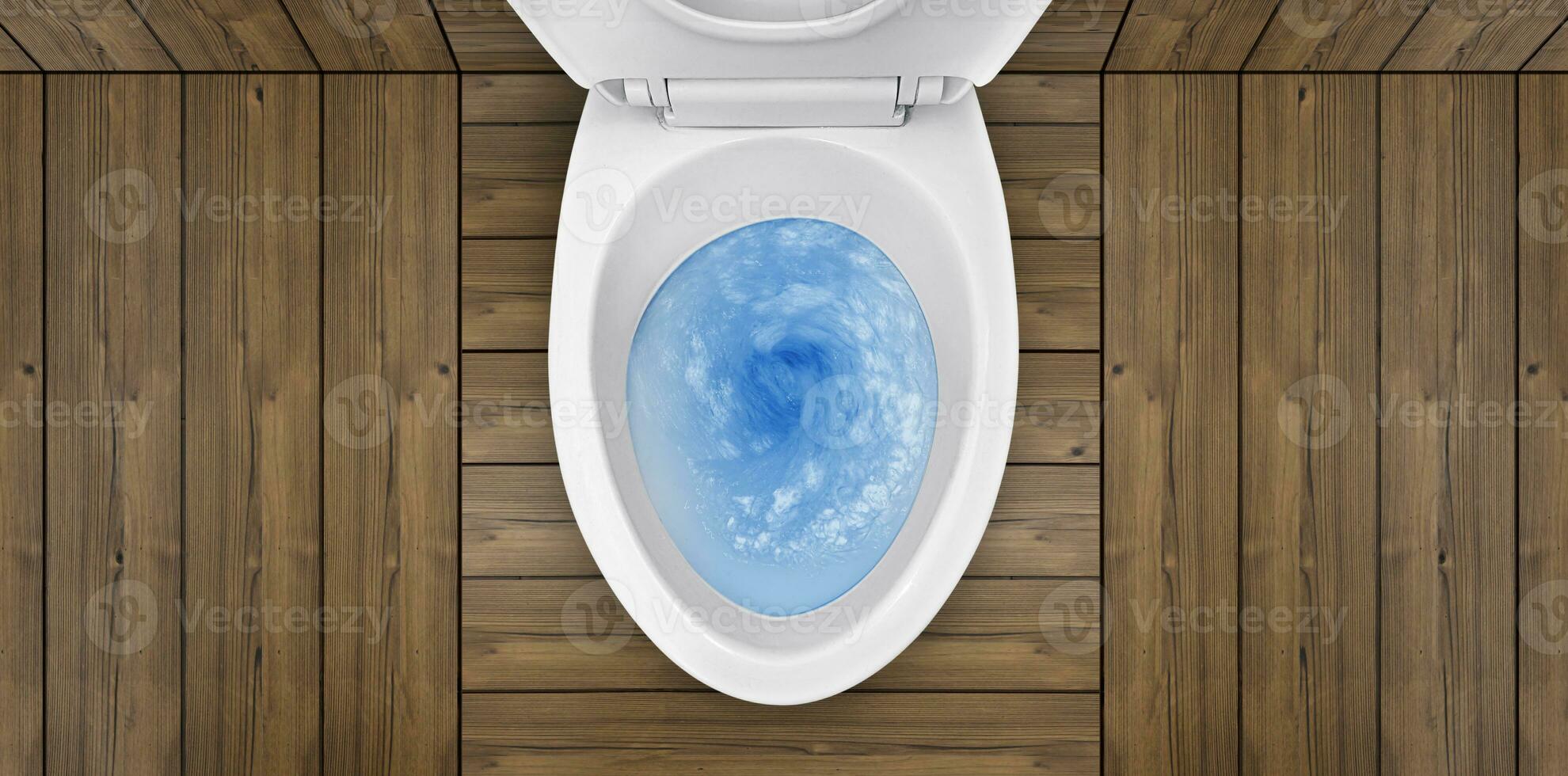 Top view of toilet bowl, blue detergent flushing in it photo