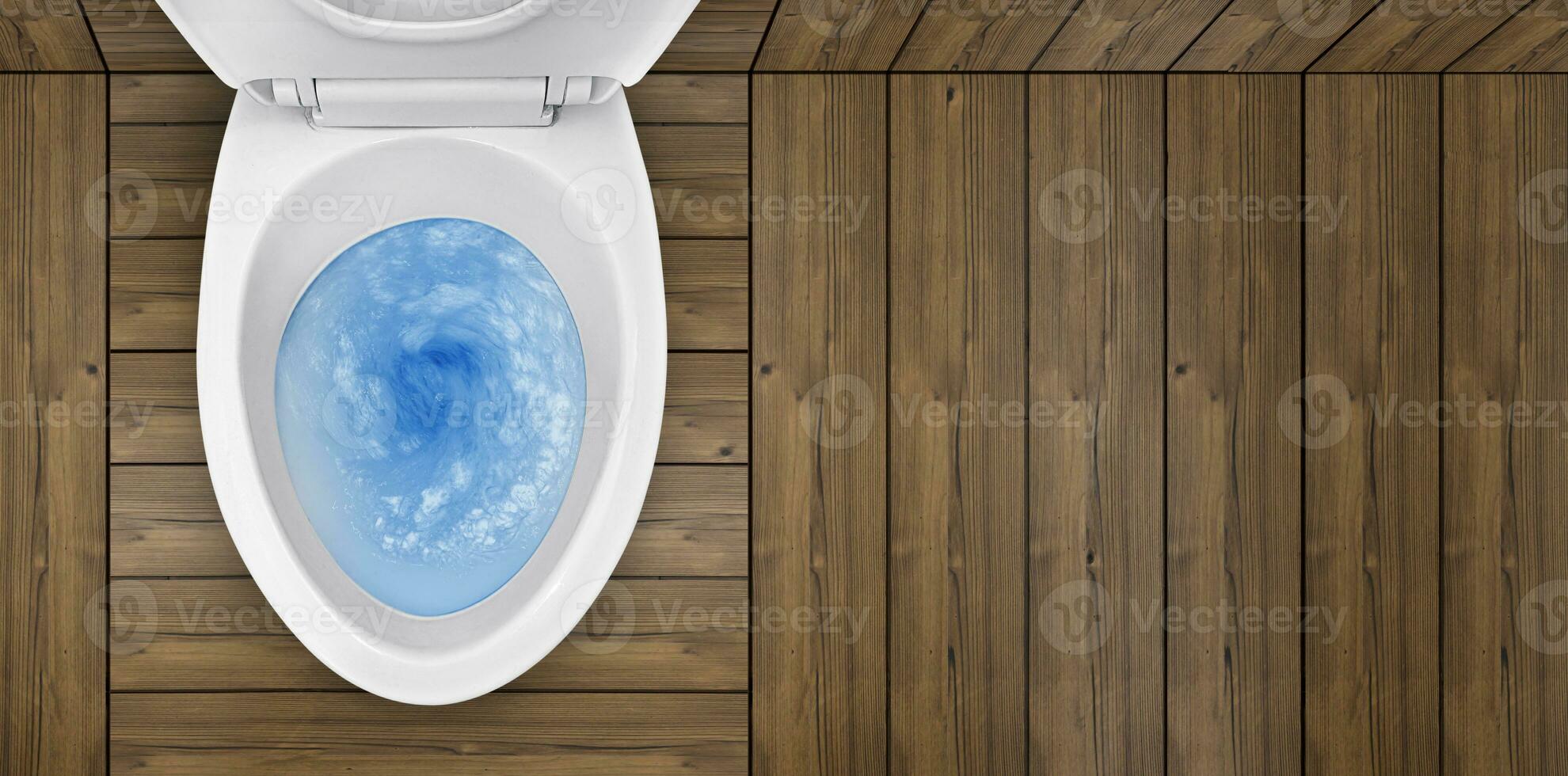 Top view of toilet bowl, blue detergent flushing in it photo