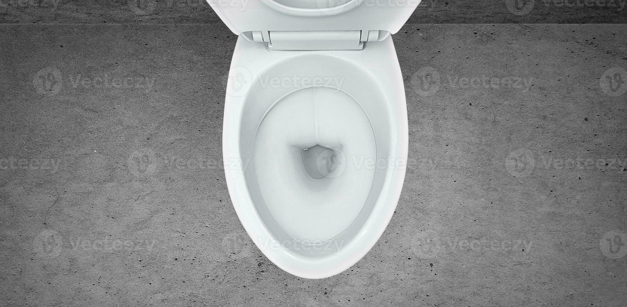 Top view of toilet bowl in the bathroom on cement background photo