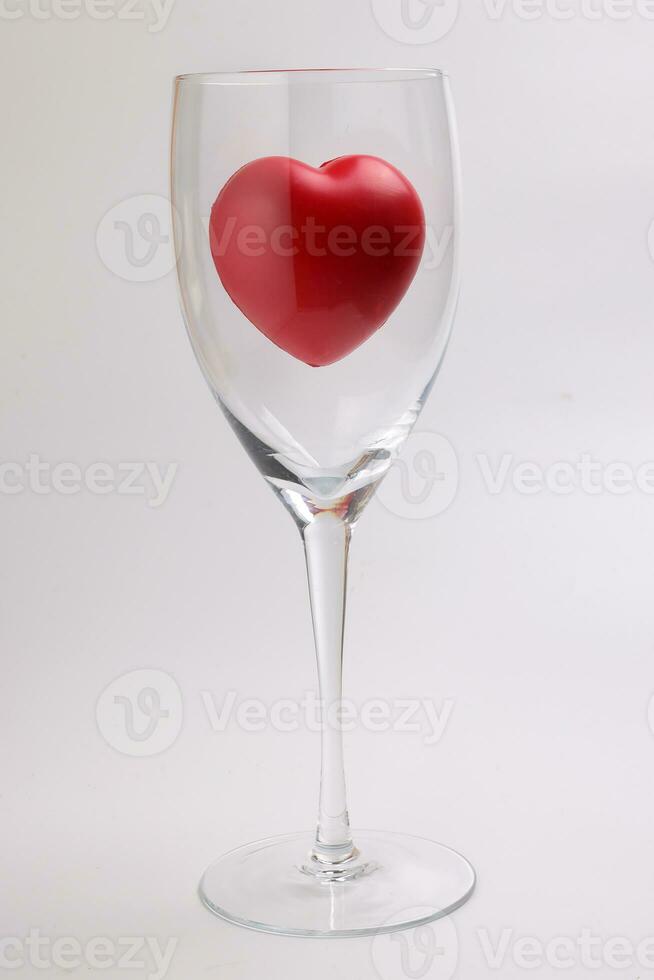 transparent wine glass with three dimension 3d red hart symbol inside on white background copy text space photo