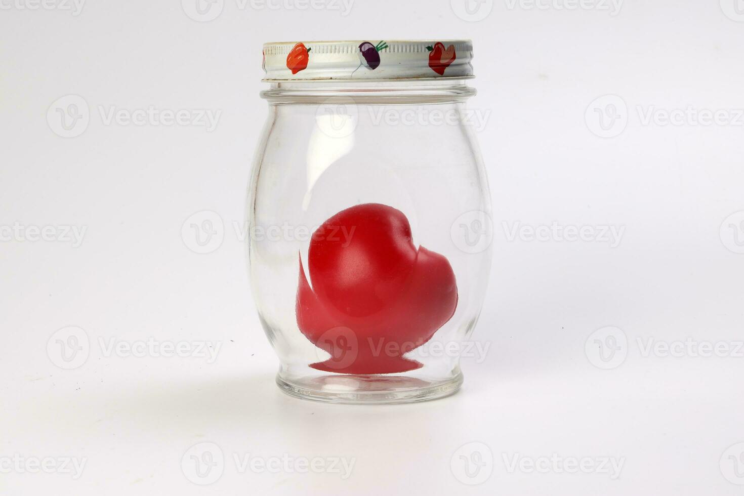 transparent glass jar with lid with three dimension 3d red hart symbol inside on white background copy text space photo