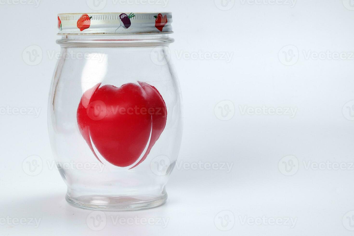 transparent glass jar with lid with three dimension 3d red hart symbol inside on white background copy text space photo