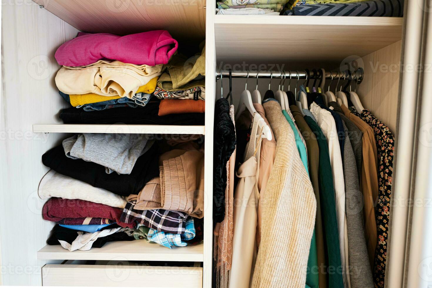 Closet with different clothes in wardrobe photo