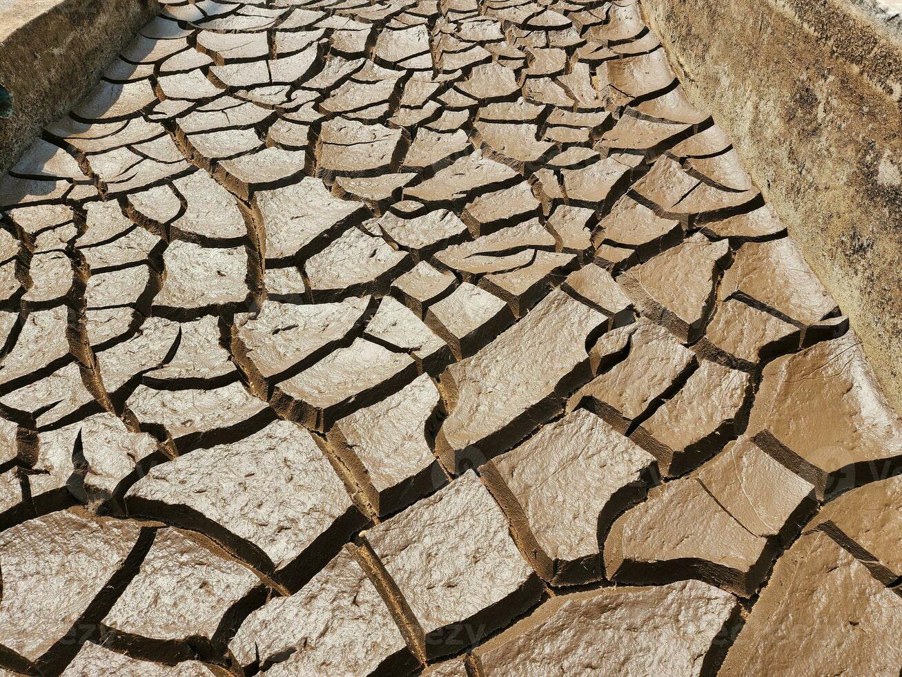 Dry and cracked soil or sediment of the treatment pond photo