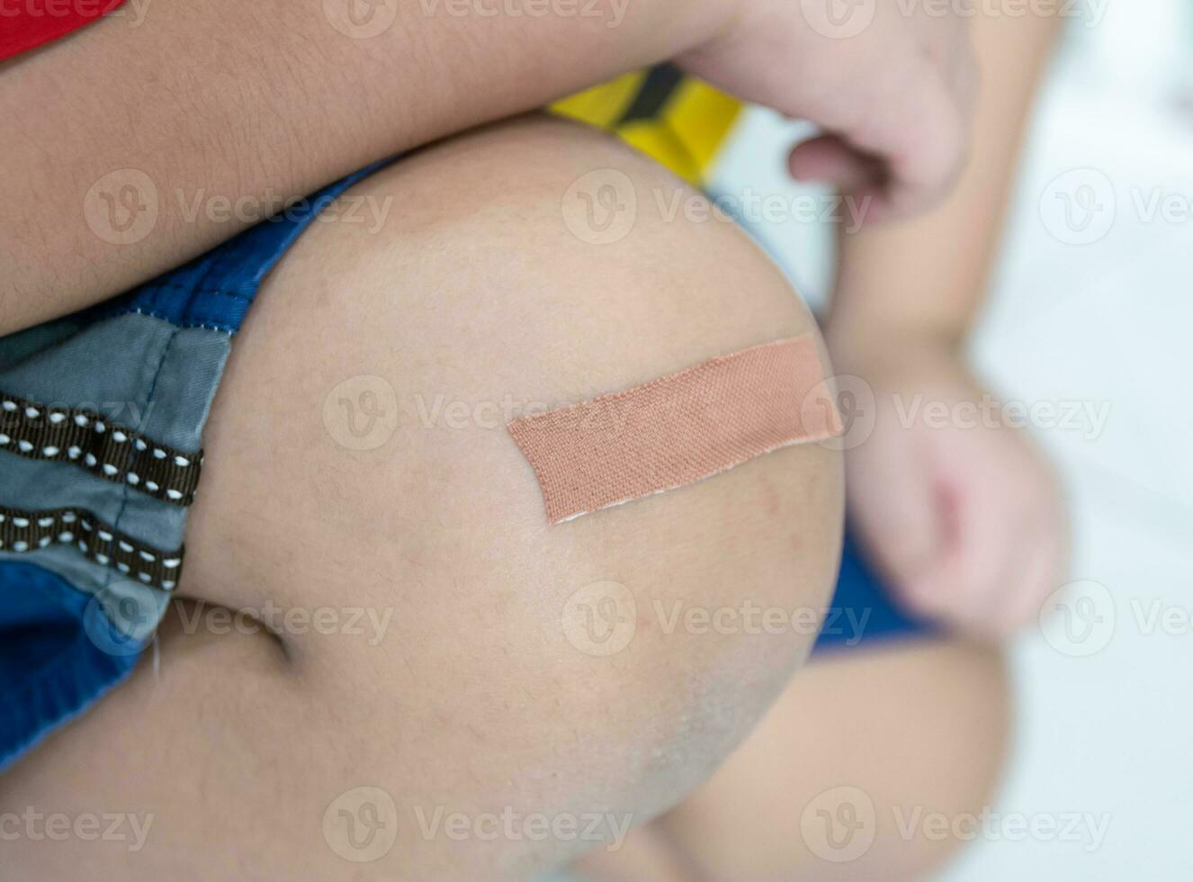 Plaster wound dressing on the child's leg photo