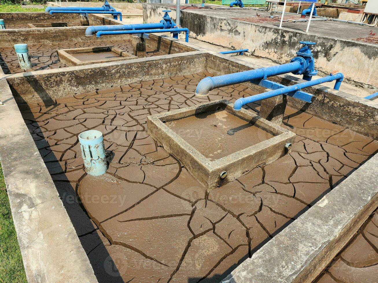 Dry and cracked soil or sediment of the treatment pond photo