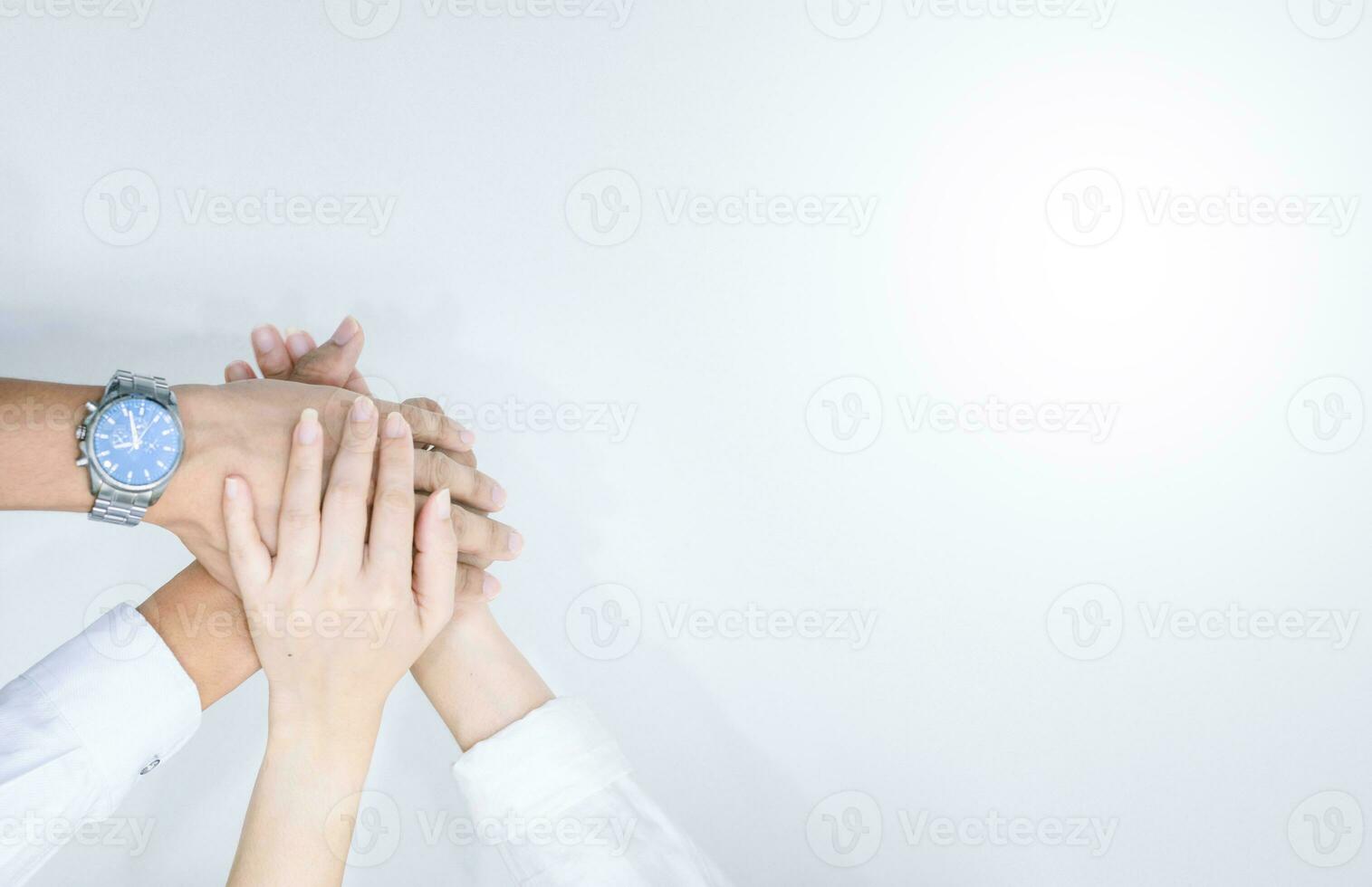 hands showing unity and teamwork clasped cooperation top view of people putting their hands photo