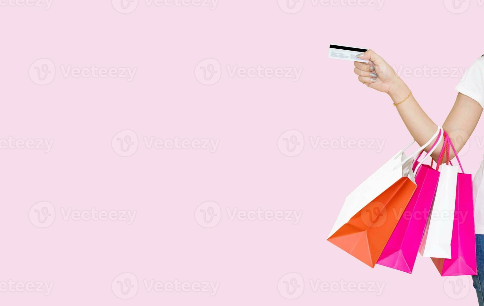 woman holding a shopping paper bag pink background photo