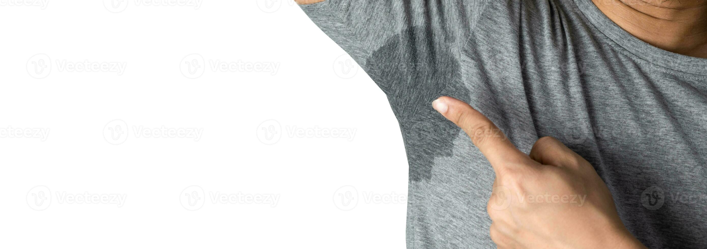 Sweaty man with stain wet armpit on t-shirt against gray free space photo