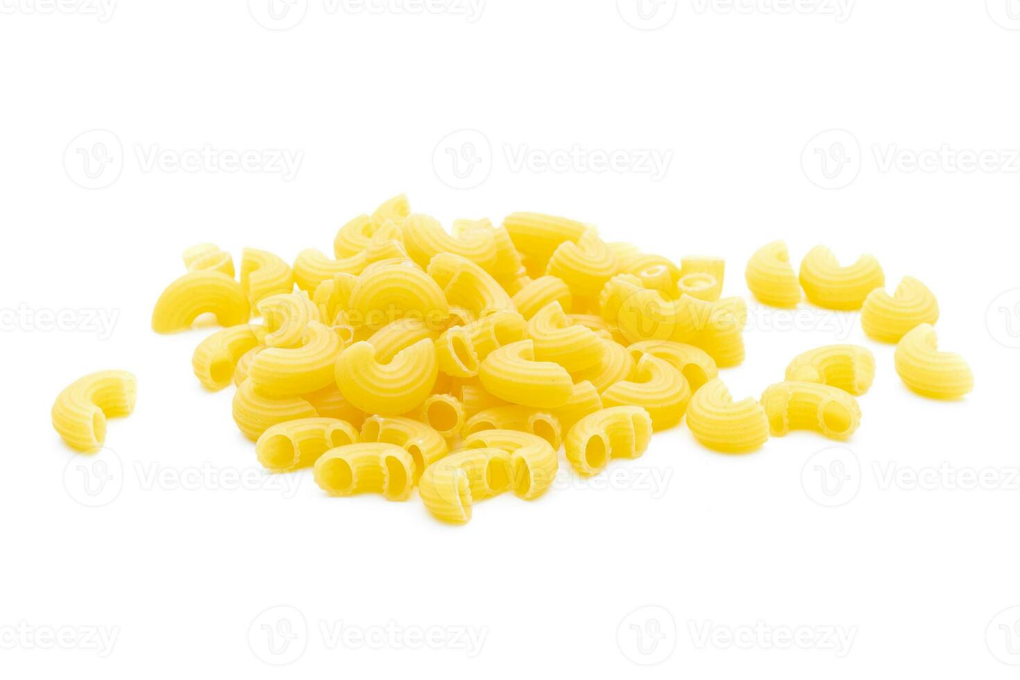 Raw macaroni on white background photo