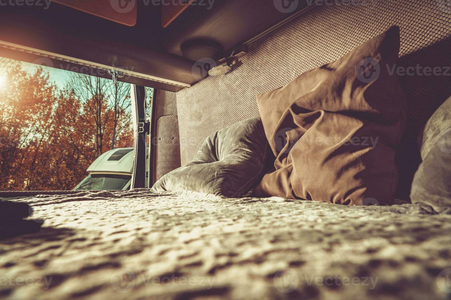 Camper Van Motorhome Comfortable Bed with the Outdoor View. photo