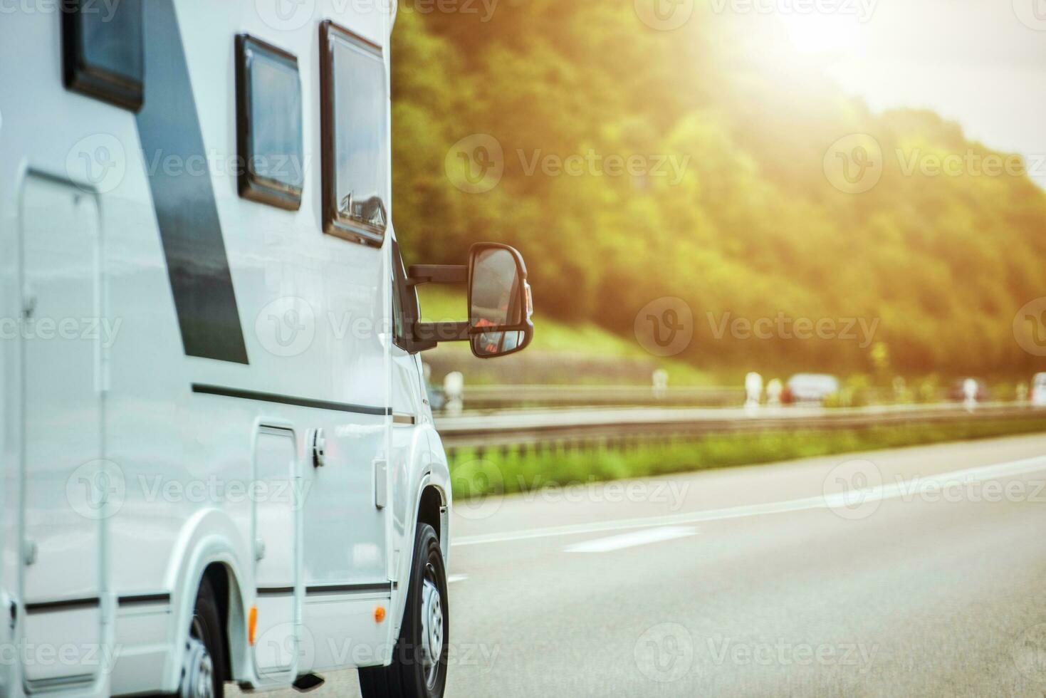 Short Mobile Camper Riding On The Road During Vacation. photo