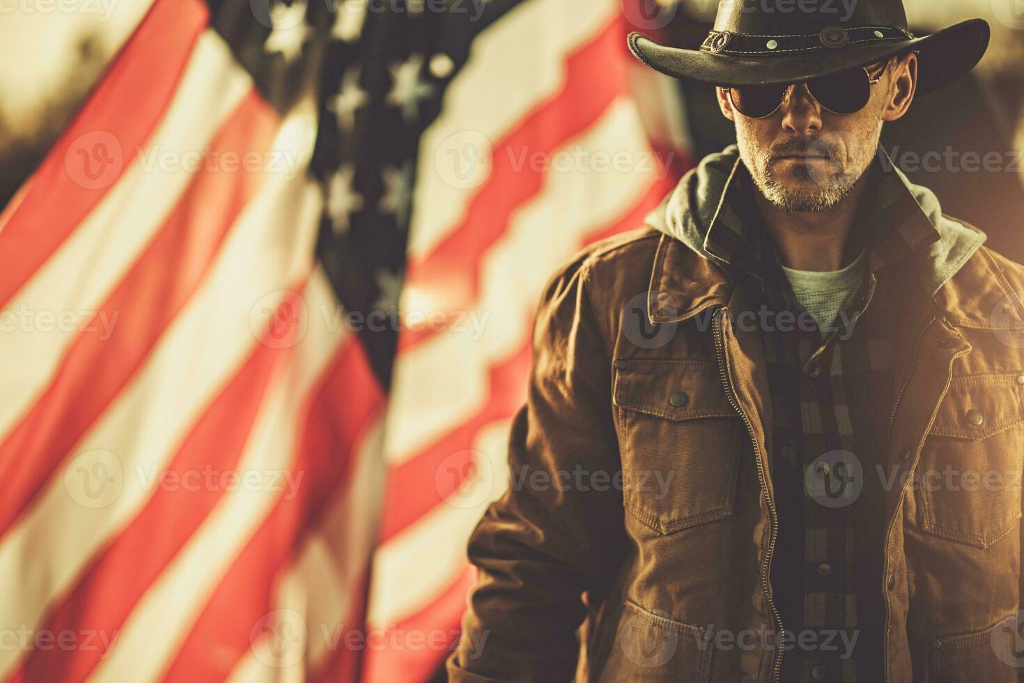 Proud American Cowboy Staying Next to USA National Flag. photo
