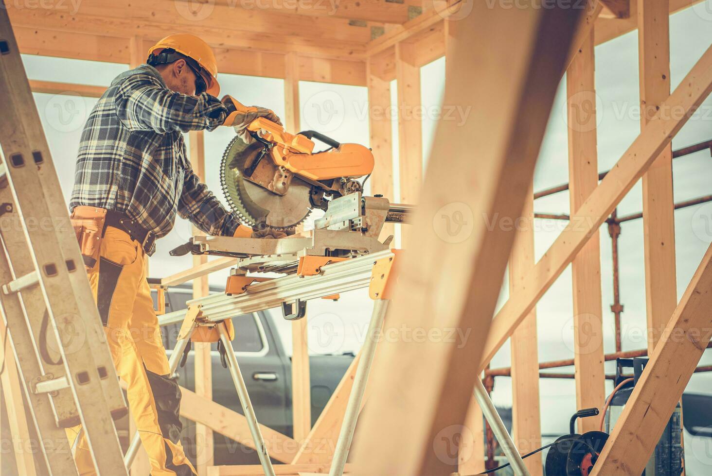 Construction Contractor Worker Using Powerful Wood Saw photo