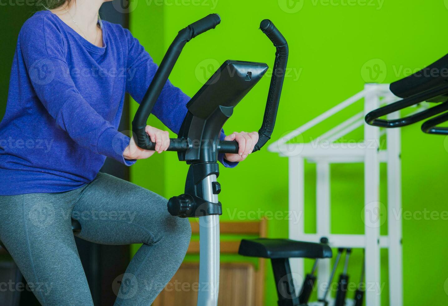 Woman Excercising On Stationary Bike. photo