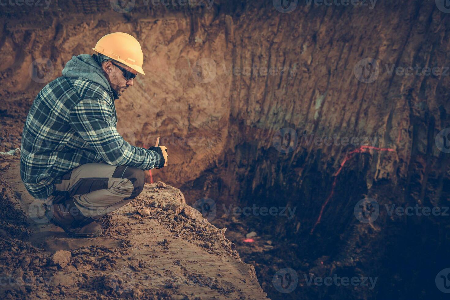 Caucasian Male Construction Geologist Surveys Natural Resources On Job Site. photo