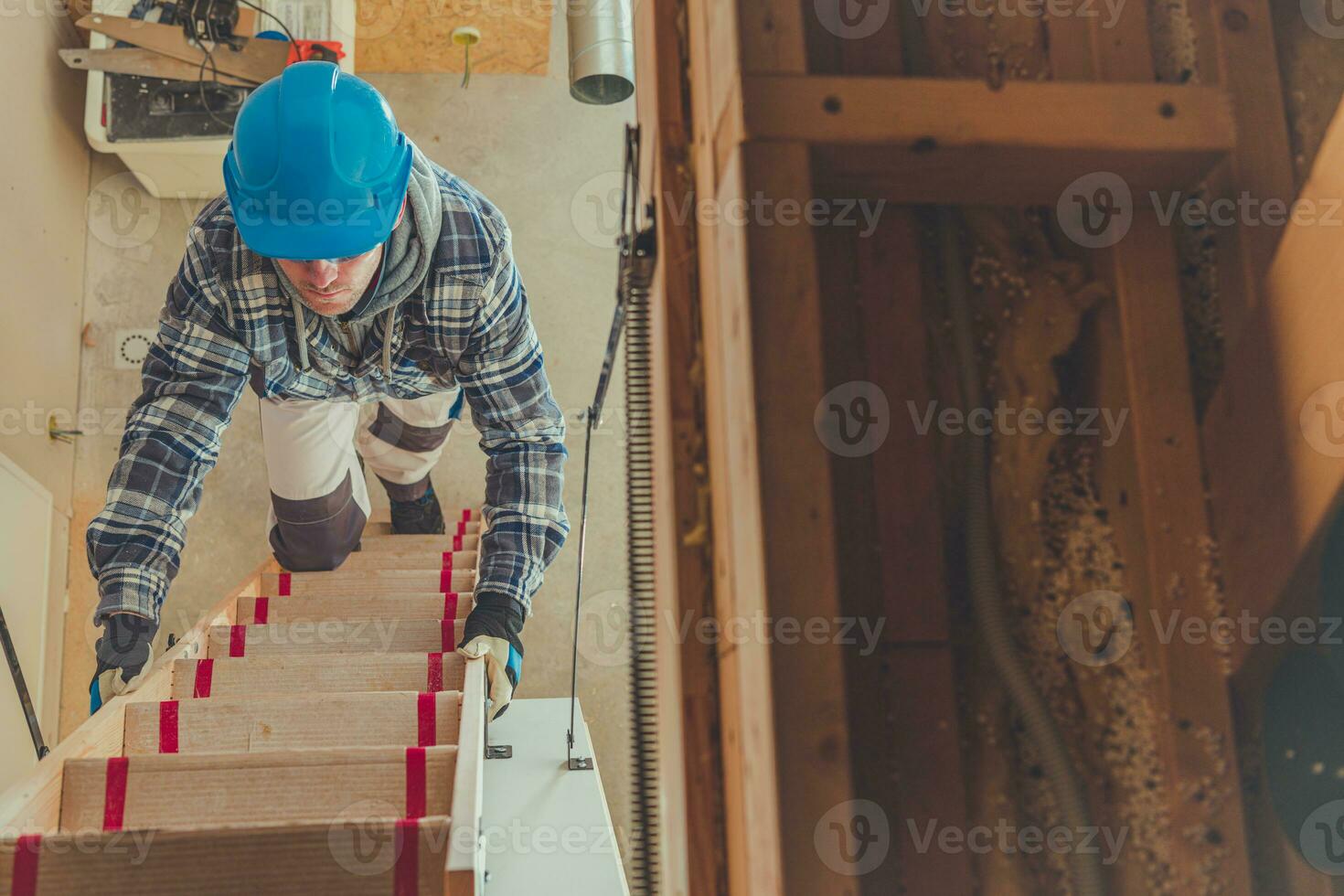 male Constrcution Worker Climbing Steps To Get To Second Floor Of House. photo