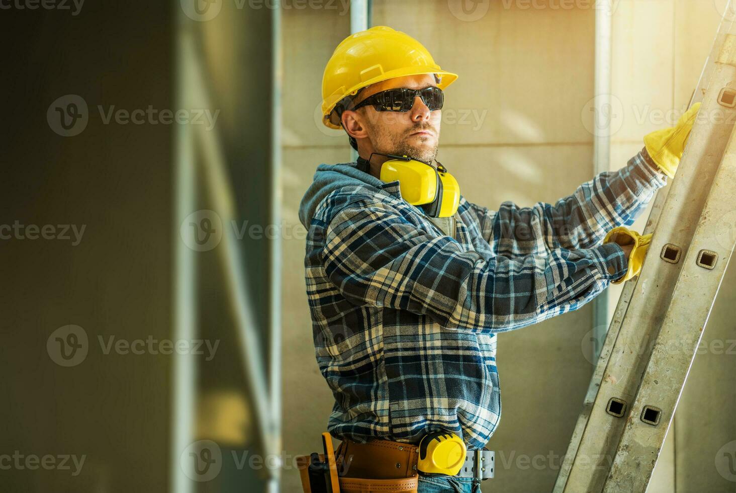 Construction Worker Unfolding a Ladder photo