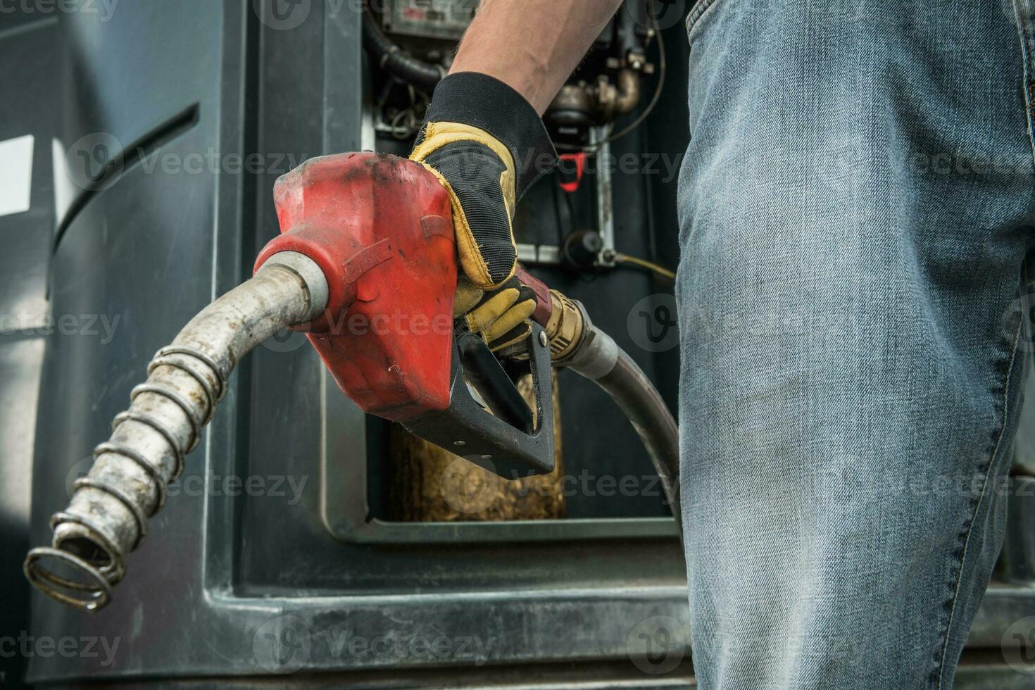 Trucker with Diesel Pump Nozzle in His Hand photo